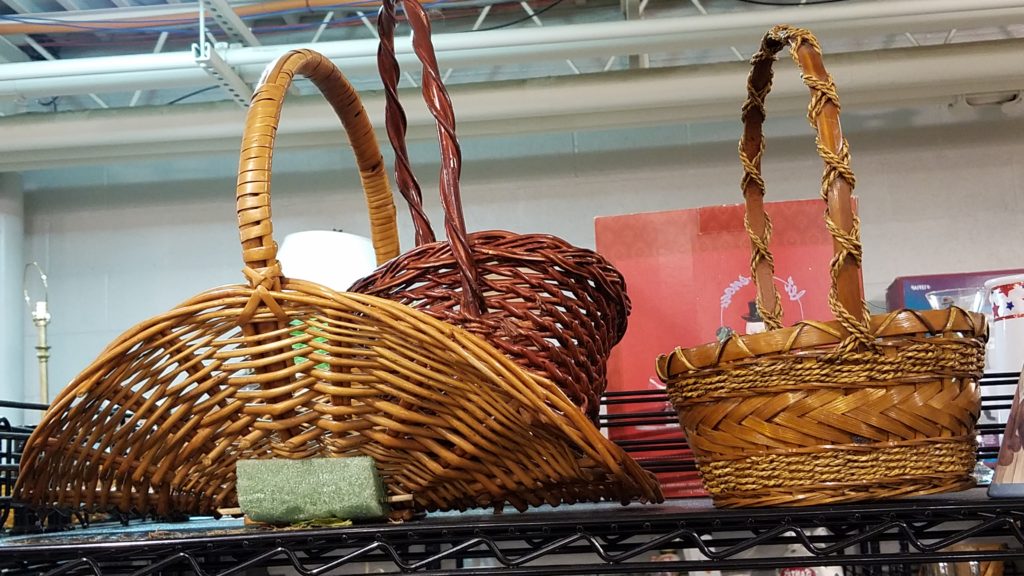 Two wicker baskets on a shelf