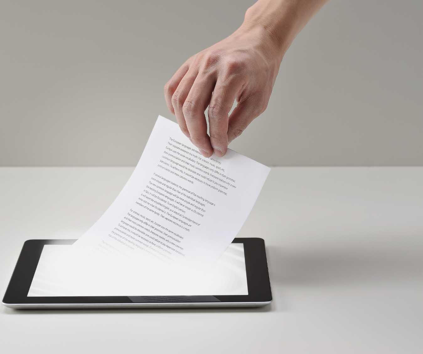 Photo illustration: paper page being pulled out of tablet