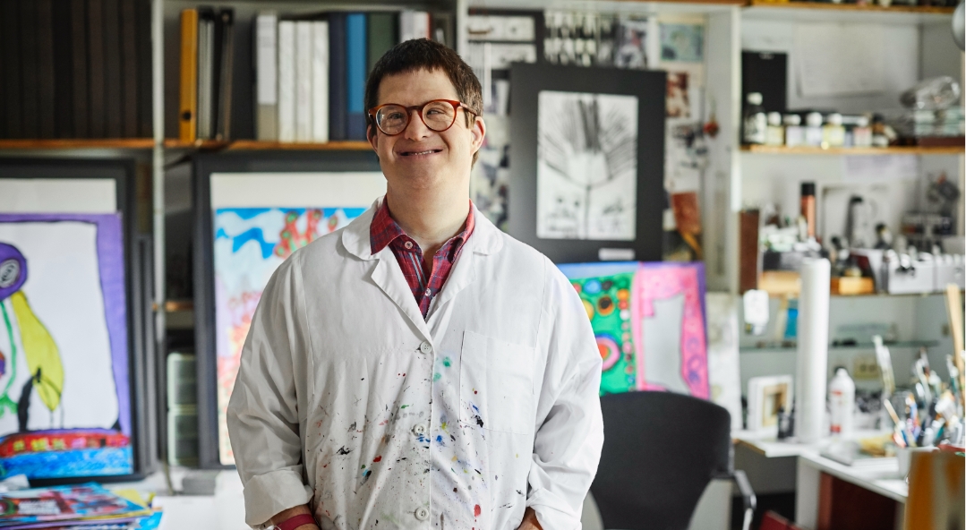 Young male painter poses in studio