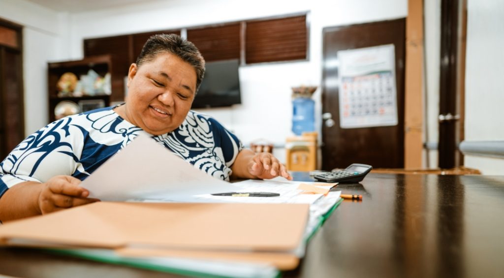 Woman works with papers at desk