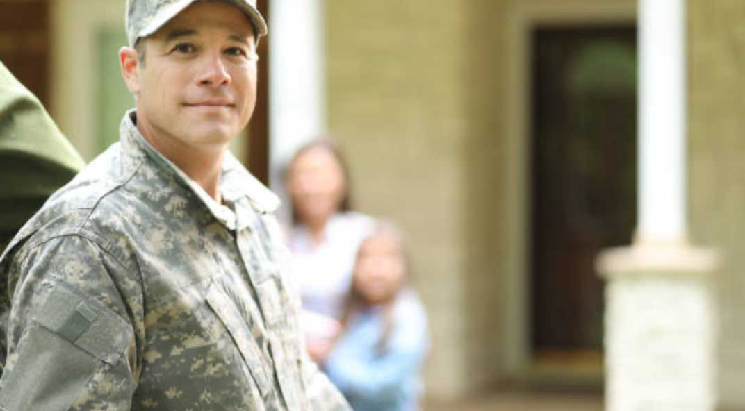 Male service member poses for camera