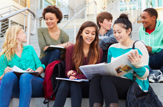 Group of students talking and studying