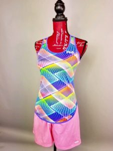 Mannequin dressed in pink, blue, green, and yellow printed tank top with pink athletic shorts.