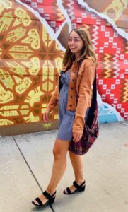 Young lady with denim jacket and dress on