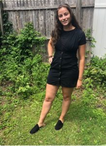 Young lady with black romper on with mules