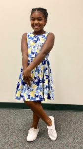 Young girl in blue and yellow dress from Goodwill