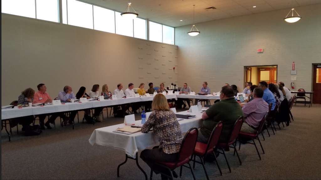 Group of conference attendees sitting at table at Bean Counters Conference