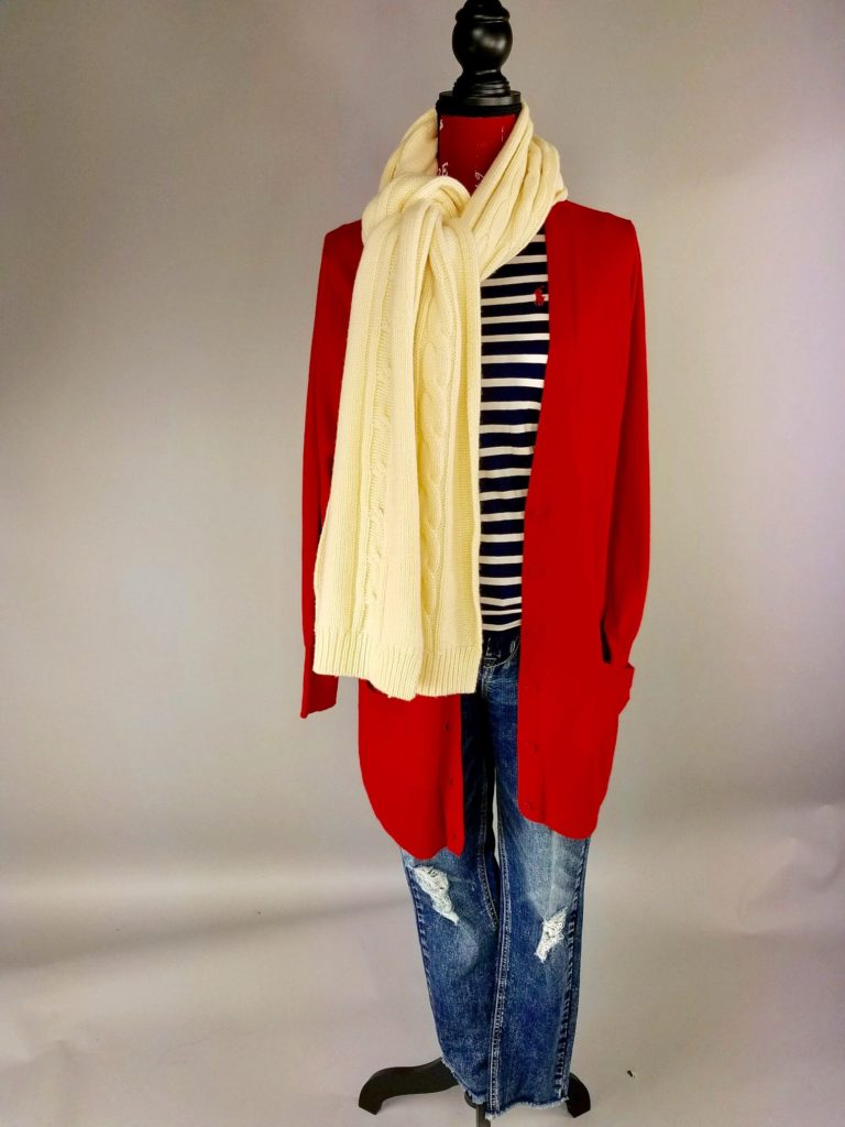 Mannequin dressed in red sweater with beige scarf