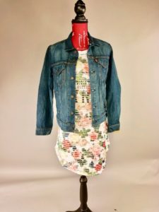 Mannequin dressed in multicolored white and pink dress with blue denim jean jacket
