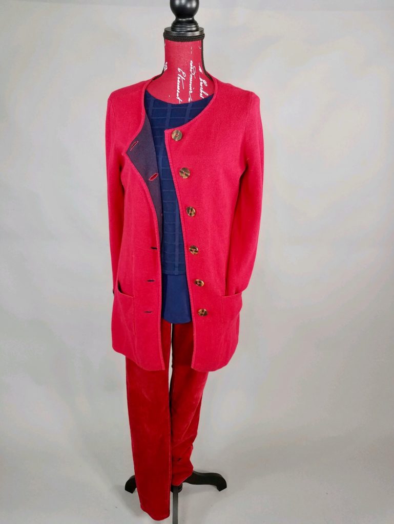Mannequin dressed in red coat with red pants and navy blouse