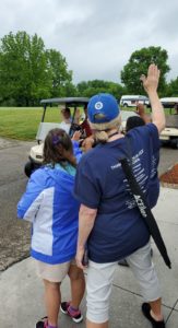 CARE team waving on golfers