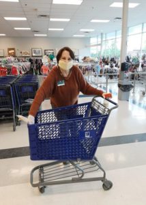 Woman cleaning carts at Ohio Valley Goodwill Tri-County Goodwill Location