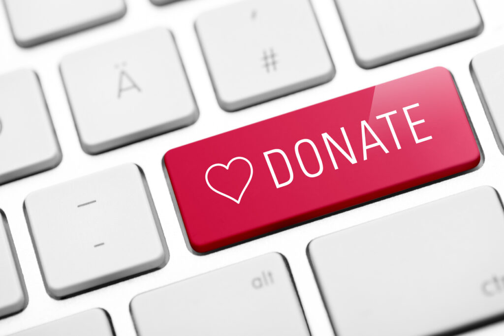 Red donate button on computer keyboard