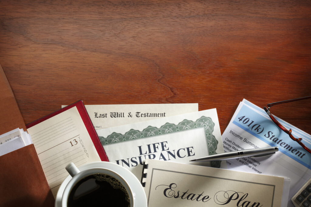 Estate planning documents with coffee on wooden desk