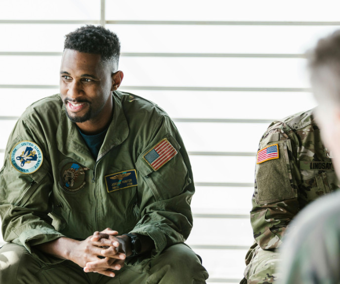 Two U.S. service members sitting and talking indoors