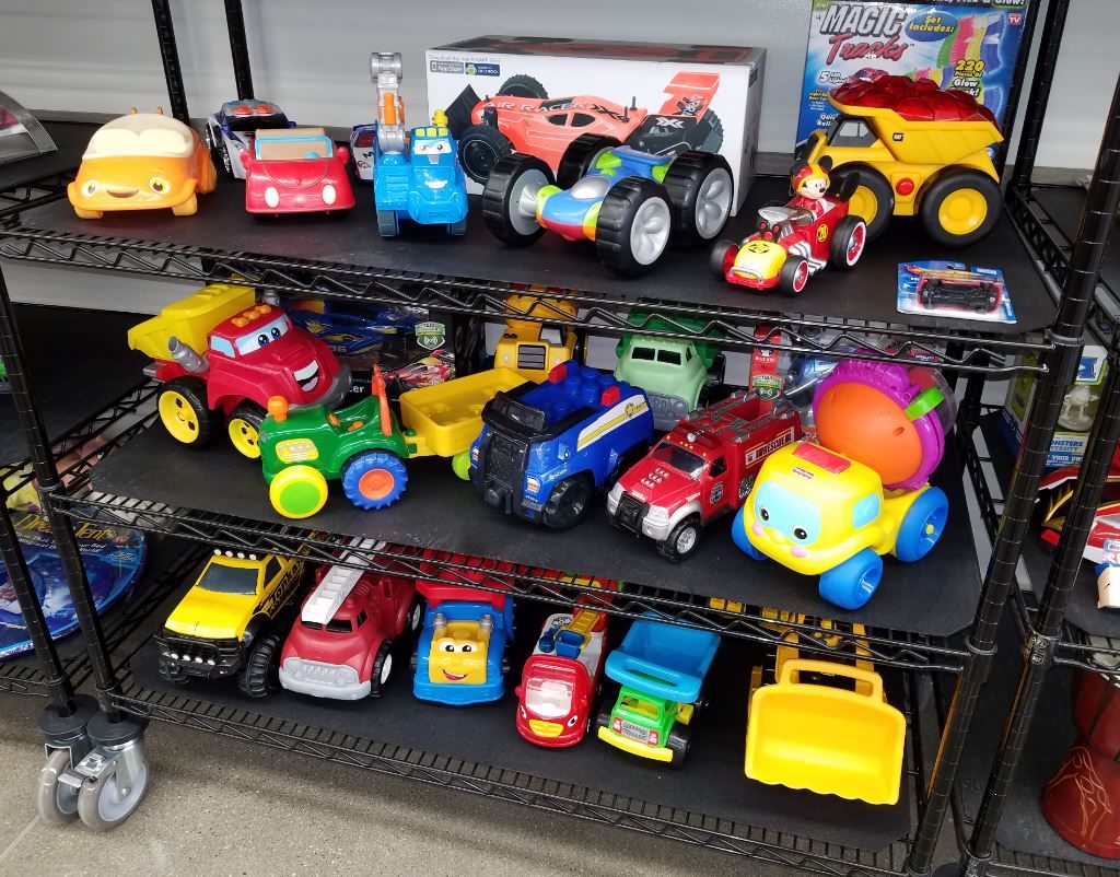 Shelf at Ohio Valley Goodwill with toddler toys and trucks