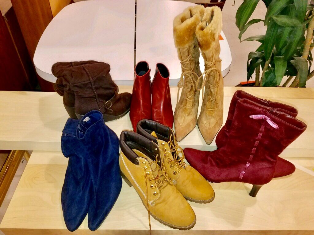 Display of six pairs of fashion boots at Goodwill store