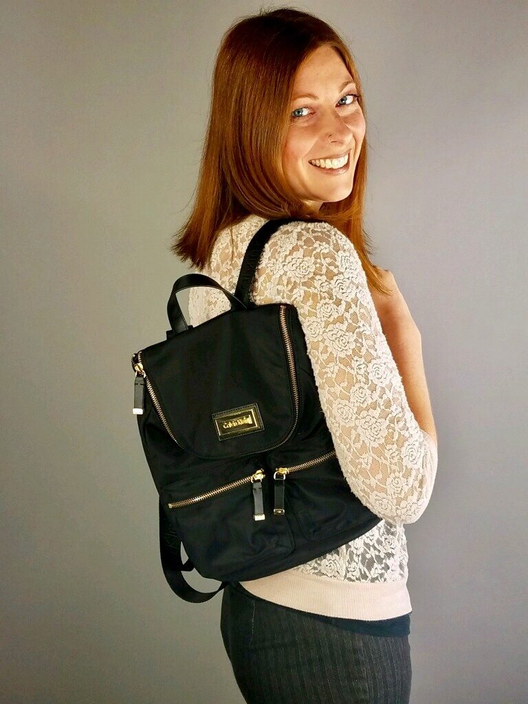 Model wearing black backpack from Ohio Valley Goodwill