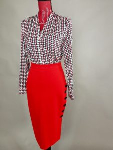 Mannequin dressed in Red and black blouse with red pencil skirt from Goodwill