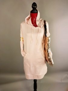 Mannequin dressed in pink hoodie with gold tote bag from Goodwill
