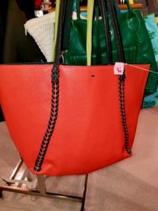 Photo of a red purse with black handles