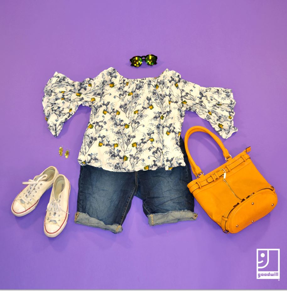 Clothing display of White blouse with jean shorts and yellow purse