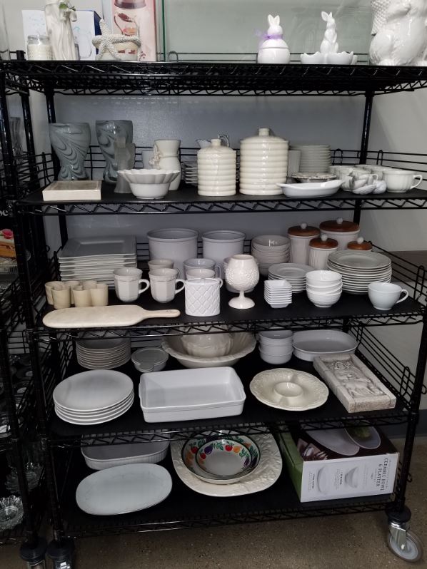 white dishes on a shelf at Goodwill