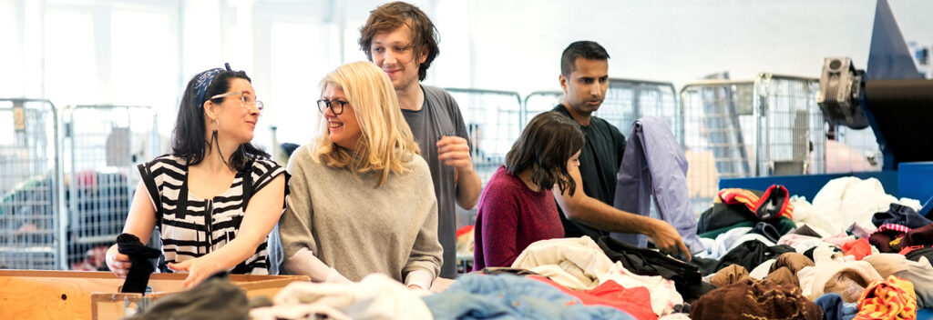 Volunteers sorting donated clothes at community center