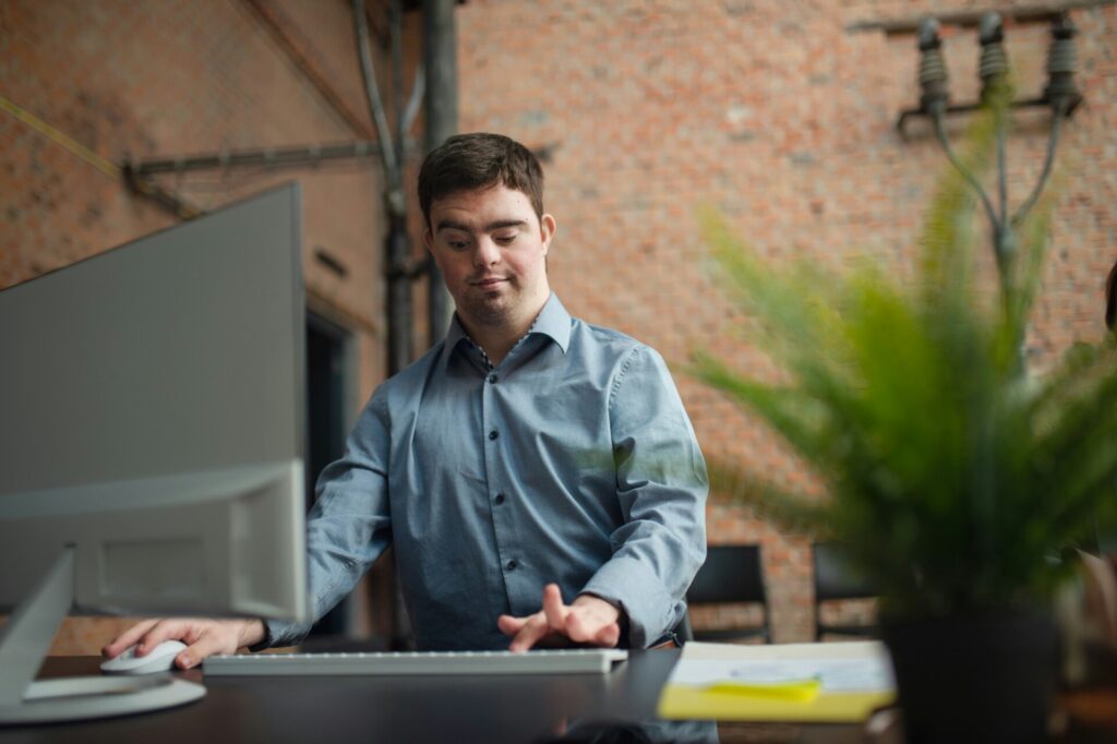 Man working at desktop computer in brick office