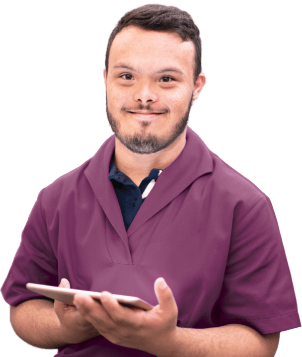 Smiling man in scrubs holding a tablet