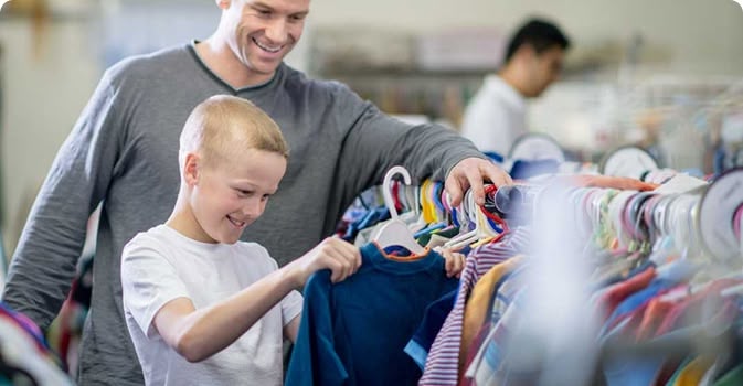 Father and son shopping for clothes together