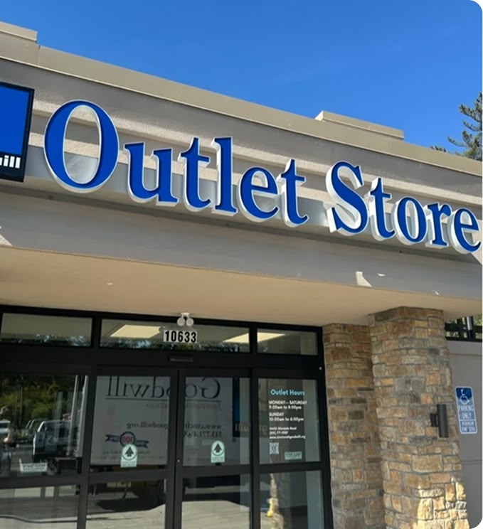 Outlet store storefront with blue sign and entrance.