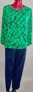 Mannequin dressed in green blouse with navy pants