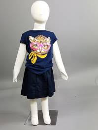 Child mannequin dressed in blue tshirt with a cat on it
