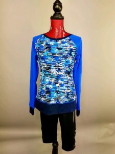 Mannequin dressed in blue athletic long sleeved shirt with black leggings